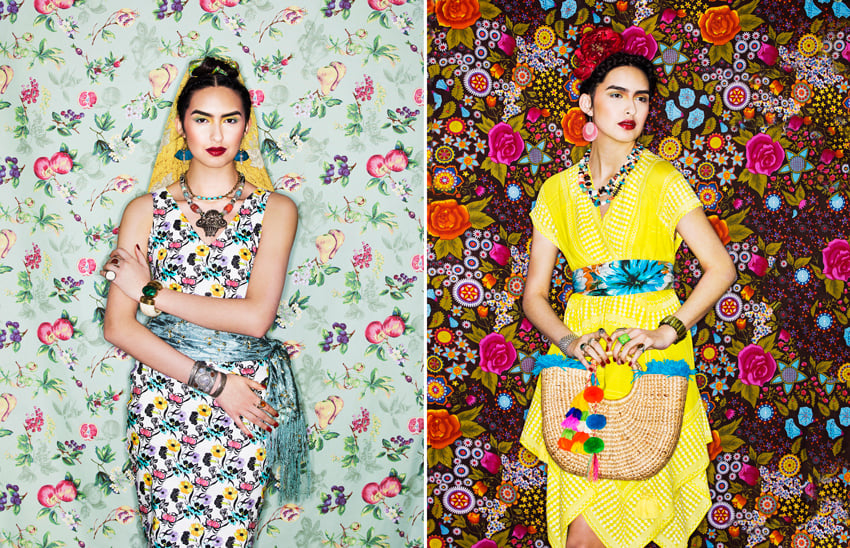 A diptych of photos by photographer Shevaun Williams featuring a model that looks like Frida Kahlo. On the left, the model appears to be standing in front of a wall with wallpaper featuring illustrations of various fruits, and wears a colorful sleeveless dress with a scarf tied around her waist. She wears statement jewelry pieces and a short yellow veil in her hair. On the right, the model wears a bright yellow wrap dress and holds a straw bag with colorful pompoms dangling from it. She stands in front of an intricate floral wallpaper design.